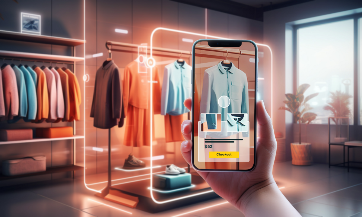 Imagem com celular apontando para roupas em manequins; conceito de phygital; compras