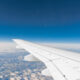 Asa de avião vista da janela, com céu azul e nuvens abaixo; 123 Milhas; Gol