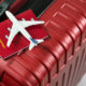 imagem de avião em miniatura em cima de passaporte e mala de viagem; 123 Milhas tem recuperação judicial suspensa