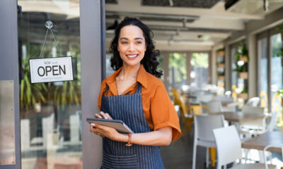 Pequena empreendedora em frente de sua loja; micro e pequenas empresas; Desenrola para MEIs